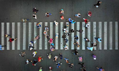An overhead photo of a busy pedestrian crosswalk.
