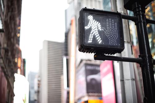 A photo of a light indicating it is safe for pedestrians to cross a street.