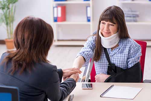 This image shows a personal injury lawyer meeting with a client.