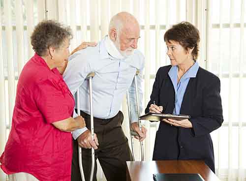 This image shows an attorney meeting with an elderly man who has been injured. A Garden City bus accident lawyer from Cellino Law will work to get you fair compensation. 