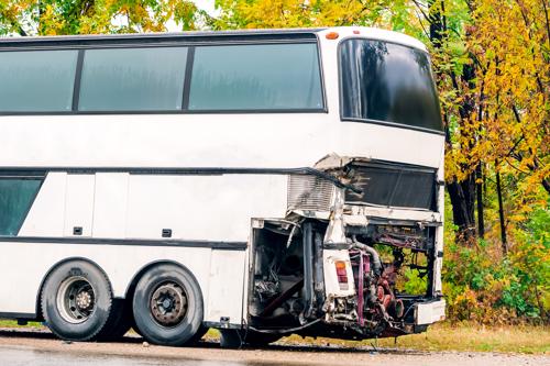 A bus heavily damaged after an accident.