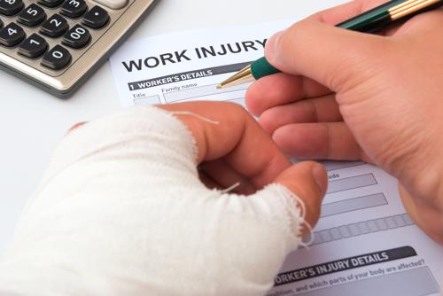 A man filling out a work injury form.