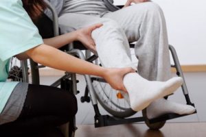 A man having an ankle injury examined by a medical professional.