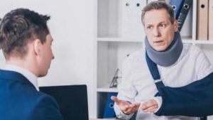A man with a neck and arm injury meeting with a lawyer in Yonkers.