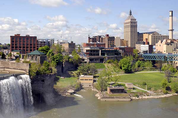 About Us view of downtown Rochester NY by a river