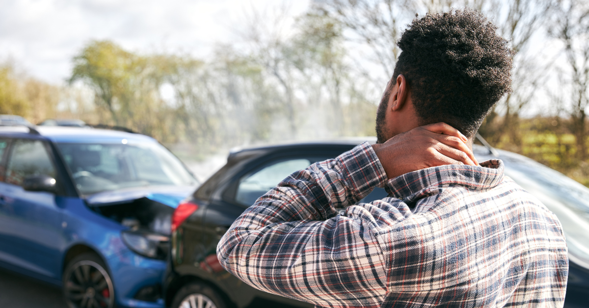 Man holding his neck in pain after car accident