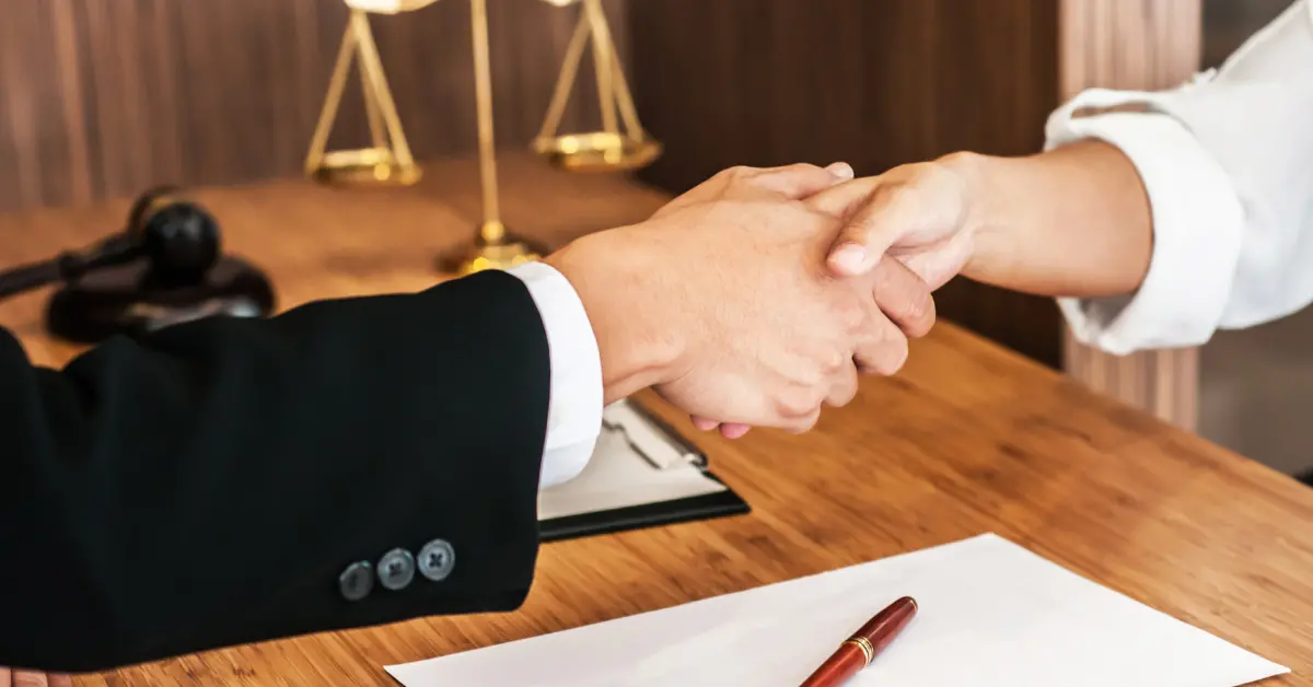 Lawyer shaking hands with client
