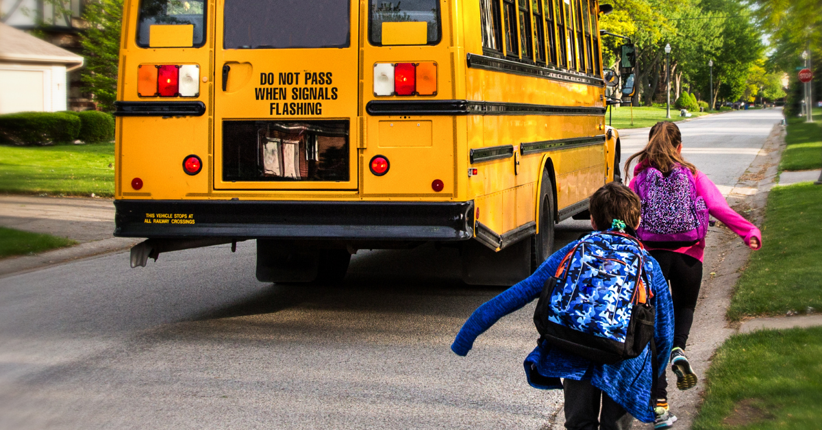 kids running to school bus
