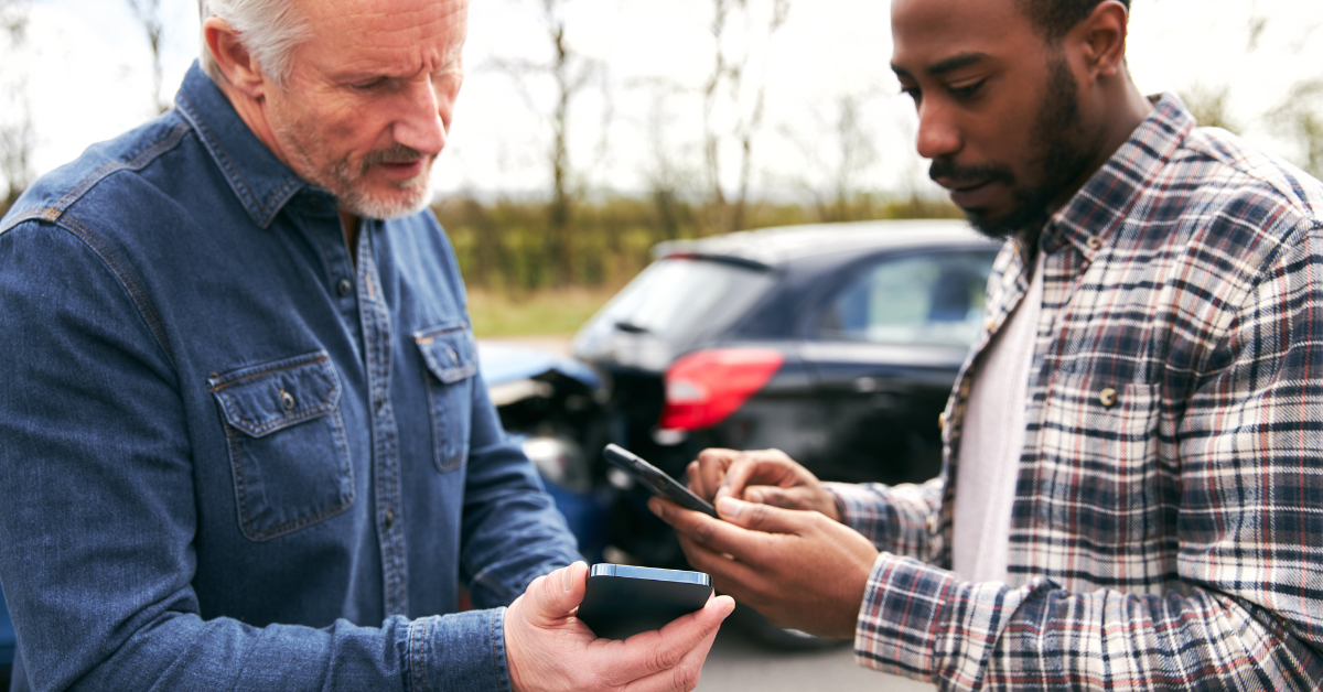 Two drivers exchange information after a car accident