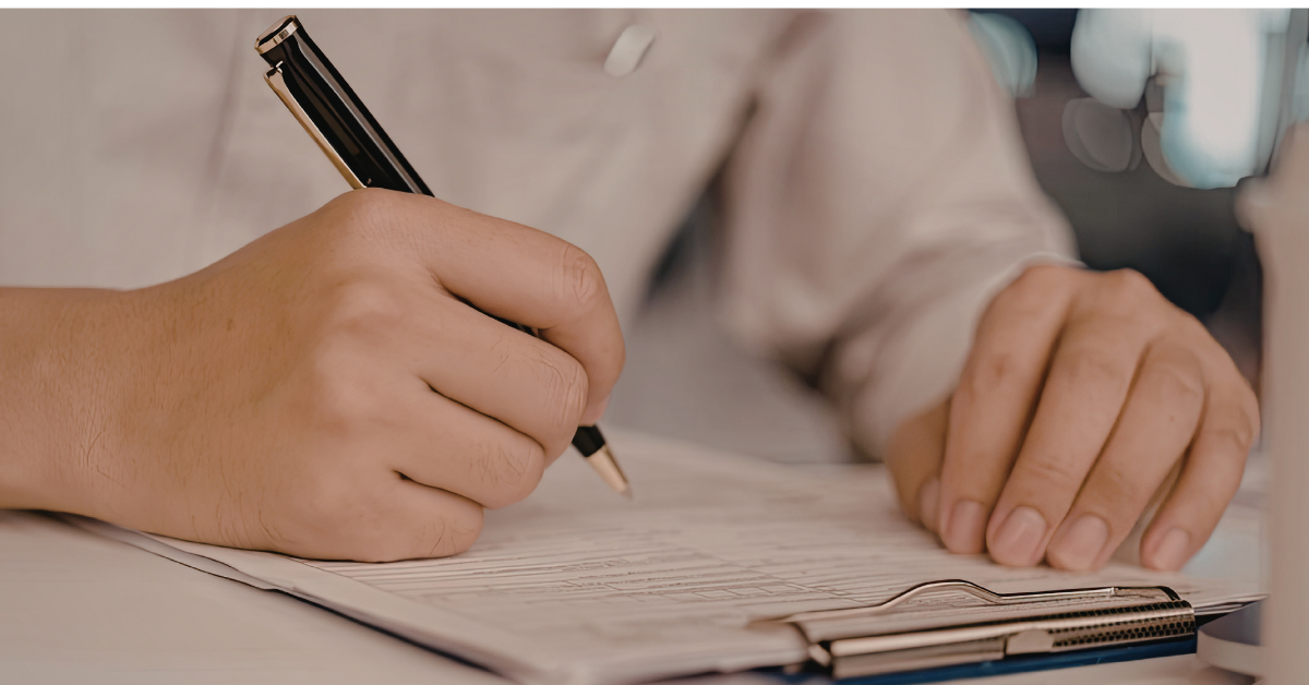 Person reviewing and filling out insurance claim forms to comply with insurance deadlines after a car accident.