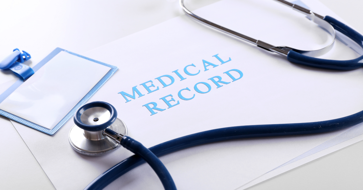 Medical records displayed on a desk with a stethoscope and badge.