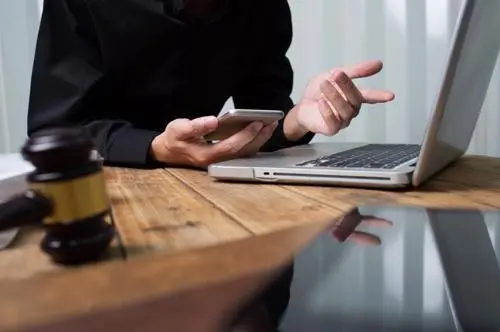 Brooklyn Wrongful Death Lawyer A Brooklyn wrongful death lawyer reviewing a case with a client on the phone.