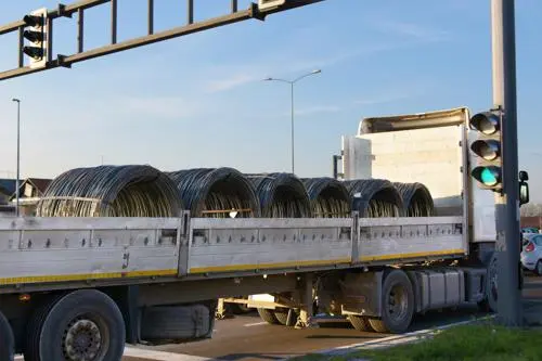 A truck transporting several large spools of wire which can cause a serious accident if not properly secured.