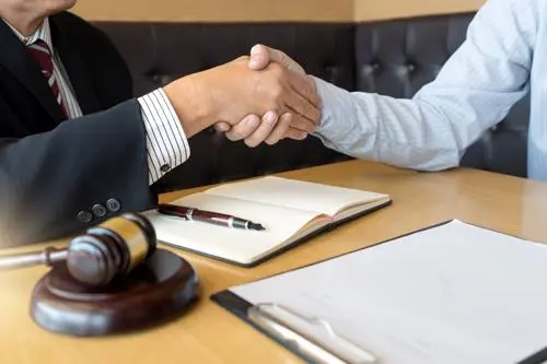 An attorney meeting with a man to discuss their potential for filing a car accident claim,