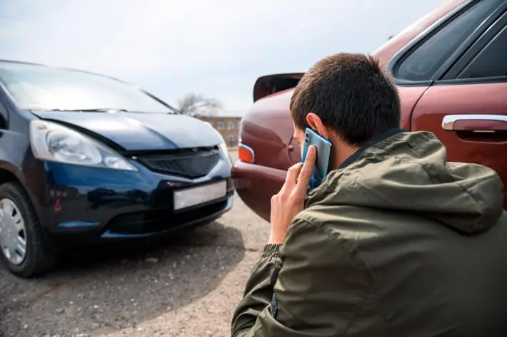 A man calling a Manhattan car accident lawyer after being rear-ended.