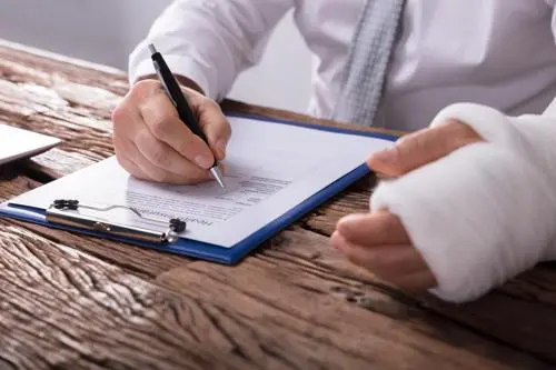 A man filling out a work injury report.