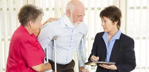 A man meeting with an attorney after suffering neck and leg injuries in a motorcycle accident.