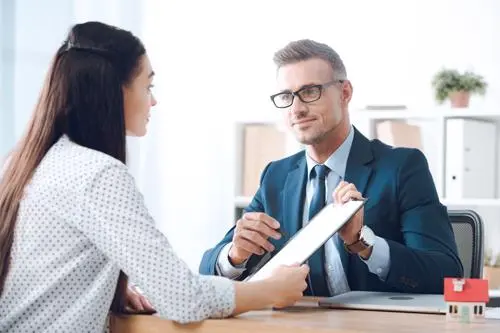 A woman discussing an injury claim with a Melville traumatic brain injury lawyer.