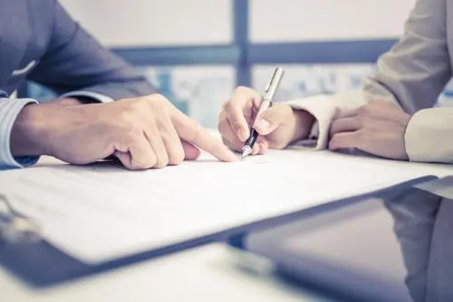 <span>New York</span> Premises Liability Lawyer An attorney reviewing a premises liability claim with a client.