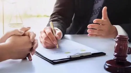 A New York City personal injury lawyer reviewing a settlement offer with a client.