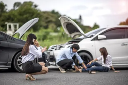 Syracuse Car Accident Lawyer A woman calling a Syracuse car accident lawyer after a head-on collision.