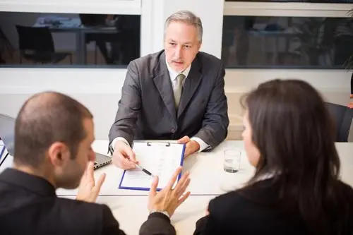 A couple reviewing a car accident claim with an attorney.