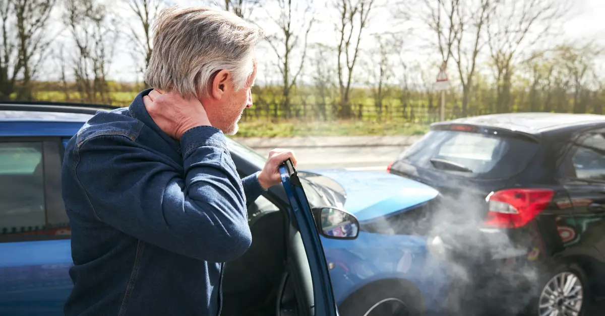Man holding his neck after getting into a car accident