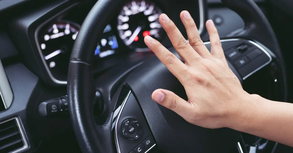 Driver pressing down on the car horn