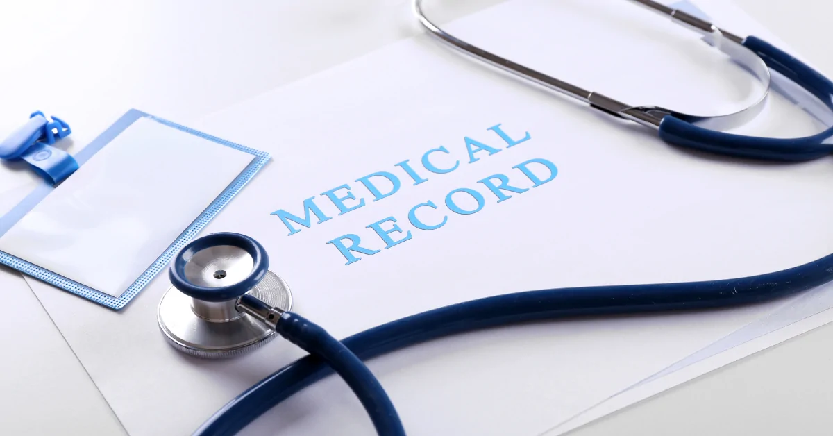 Medical records displayed on a desk with a stethoscope and badge.